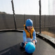 Toddler boy playing with ball on trampoline outdoors Toddler boy playing with ball on trampoline outdoors - PhotoDune Item for Sale