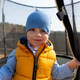 Young boy smiling inside trampoline enclosure Young boy smiling inside trampoline enclosure - PhotoDune Item for Sale