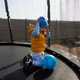 Toddler boy playing with a blue ball on a trampoline Toddler boy playing with a blue ball on a trampoline - PhotoDune Item for Sale