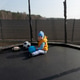 Toddler boy playing with balls on trampoline outdoors Toddler boy playing with balls on trampoline outdoors - PhotoDune Item for Sale