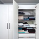 Wardrobe interior displaying folded clothes and towels on shelves Wardrobe interior displaying folded clothes and towels on shelves - PhotoDune Item for Sale