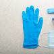 Medical face mask, glasses, hat and gloves laying on table flat lay view with copy-space Medical face mask, glasses, hat and gloves laying on table flat lay view with copy-space - PhotoDune Item for Sale