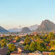 Paragliders soaring above Vang Vieng during sunrise in Laos Paragliders soaring above Vang Vieng during sunrise in Laos - PhotoDune Item for Sale