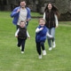 Happy Family Running Toward Camera Together in Park Happy Family Running Toward Camera Together in Park - PhotoDune Item for Sale