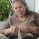 Senior Woman Mending Clothing by Hand Indoors Senior Woman Mending Clothing by Hand Indoors - PhotoDune Item for Sale