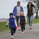 Happy Family Walking Toward Camera Together in Park Happy Family Walking Toward Camera Together in Park - PhotoDune Item for Sale