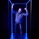 Young man with skeleton face paint posing confidently inside neon blue light box in dark studio Young man with skeleton face paint posing confidently inside neon blue light box in dark studio - PhotoDune Item for Sale