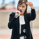 Young woman cosplay singer with long dark hair and headpiece performing outdoors with microphone Young woman cosplay singer with long dark hair and headpiece performing outdoors with microphone - PhotoDune Item for Sale