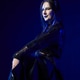Young woman with long black hair and gothic makeup wearing black dress on dark blue background Young woman with long black hair and gothic makeup wearing black dress on dark blue background - PhotoDune Item for Sale