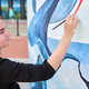 Young artist painting blue and red mural outdoors under daylight with focused expression Young artist painting blue and red mural outdoors under daylight with focused expression - PhotoDune Item for Sale