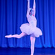 Elegant ballerina performing grand jete on stage with blue lighting and stage curtain background Elegant ballerina performing grand jete on stage with blue lighting and stage curtain background - PhotoDune Item for Sale