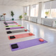 Spacious bright yoga studio with neatly arranged mats and props along sunny windowed wall Spacious bright yoga studio with neatly arranged mats and props along sunny windowed wall - PhotoDune Item for Sale