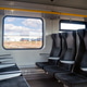 Train interior with empty seats and a view outside during daytime Train interior with empty seats and a view outside during daytime - PhotoDune Item for Sale