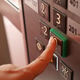 Pressing the elevator button in a bustling building Pressing the elevator button in a bustling building - PhotoDune Item for Sale