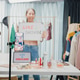Young Asia lady beauty blogger wear crop top hold whiteboard smile looking at phone live stream came Young Asia lady beauty blogger wear crop top hold whiteboard smile looking at phone live stream came - PhotoDune Item for Sale