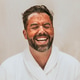 Laughing man in robe with facial mask isolated on background Laughing man in robe with facial mask isolated on background - PhotoDune Item for Sale