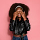 Shy woman covering her eyes, pink background Shy woman covering her eyes, pink background - PhotoDune Item for Sale