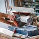 Carpenter Operating Miter Saw to Cut Wood in Workshop Carpenter Operating Miter Saw to Cut Wood in Workshop - PhotoDune Item for Sale