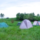 Several camping tents in green field, surrounded by nature, outdoor tourism concept, adventure trave Several camping tents in green field, surrounded by nature, outdoor tourism concept, adventure trave - PhotoDune Item for Sale