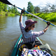Woman raises paddle above head while kayaking, river trip, active water sport, summer adventure, ene Woman raises paddle above head while kayaking, river trip, active water sport, summer adventure, ene - PhotoDune Item for Sale