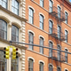 Old building with iron fire escape, New York City, USA. Old building with iron fire escape, New York City, USA. - PhotoDune Item for Sale