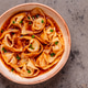 Wontons are placed in a bowl with spicy sauce. Wontons are placed in a bowl with spicy sauce. - PhotoDune Item for Sale