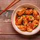 Delicious dumplings served in a bowl with a spicy sauce and green onions Delicious dumplings served in a bowl with a spicy sauce and green onions - PhotoDune Item for Sale