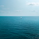 Minimalist seascape with a white sailboat in the middle of the deep blue ocean, Thailand Minimalist seascape with a white sailboat in the middle of the deep blue ocean, Thailand - PhotoDune Item for Sale