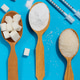 Sugar spoons and insulin syringes on a blue background symbolize the risk of diabetes and addiction Sugar spoons and insulin syringes on a blue background symbolize the risk of diabetes and addiction - PhotoDune Item for Sale