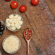 Pizza ingredients with mozzarella, grated cheese, cherry tomatoes, olives, spices in a spoon and gra Pizza ingredients with mozzarella, grated cheese, cherry tomatoes, olives, spices in a spoon and gra - PhotoDune Item for Sale