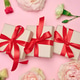 Gift boxes tied with a red ribbon and blooming white and green carnations Gift boxes tied with a red ribbon and blooming white and green carnations - PhotoDune Item for Sale