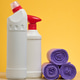 White plastic bottles of household chemicals with red lids and rolls of purple garbage bags on a yel White plastic bottles of household chemicals with red lids and rolls of purple garbage bags on a yel - PhotoDune Item for Sale