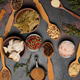 Various ground spices in wooden spoons, peppercorns on dark table Various ground spices in wooden spoons, peppercorns on dark table - PhotoDune Item for Sale