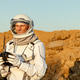 Exploration on the surface of Mars during a mission by an astronaut in a spacesuit Exploration on the surface of Mars during a mission by an astronaut in a spacesuit - PhotoDune Item for Sale