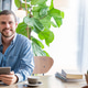 Young tattooed man sitting at a modern cafe, using a tablet near a window Young tattooed man sitting at a modern cafe, using a tablet near a window - PhotoDune Item for Sale