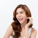 Woman Smiling With Healthy Teeth During Skin Care Routine in Bright Setting Woman Smiling With Healthy Teeth During Skin Care Routine in Bright Setting - PhotoDune Item for Sale
