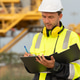Industrial engineer holding a check list clipboard and walkie-talkie at an offshore energy platform. Industrial engineer holding a check list clipboard and walkie-talkie at an offshore energy platform. - PhotoDune Item for Sale