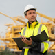 Industrial engineer holding a check list clipboard and walkie-talkie at an offshore energy platform. Industrial engineer holding a check list clipboard and walkie-talkie at an offshore energy platform. - PhotoDune Item for Sale