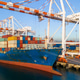 Cargo Container Ship Docked at a Commercial Port Terminal With Giant Gantry Cranes Loading Freight, Cargo Container Ship Docked at a Commercial Port Terminal With Giant Gantry Cranes Loading Freight, - PhotoDune Item for Sale