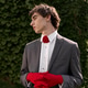 Young man in a grey suit and red gloves enjoys summer in the park Young man in a grey suit and red gloves enjoys summer in the park - PhotoDune Item for Sale
