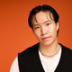 Stylish young man showcases modern fashion in vibrant orange studio setting Stylish young man showcases modern fashion in vibrant orange studio setting - PhotoDune Item for Sale