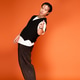 Stylish young man poses in an orange studio showcasing modern fashion trends Stylish young man poses in an orange studio showcasing modern fashion trends - PhotoDune Item for Sale