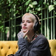 Cozy moments in a vibrant cafe with a stylish non binary person enjoying their time Cozy moments in a vibrant cafe with a stylish non binary person enjoying their time - PhotoDune Item for Sale