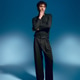 Stylish young man exudes elegance and confidence in a striking pose against a blue backdrop Stylish young man exudes elegance and confidence in a striking pose against a blue backdrop - PhotoDune Item for Sale