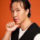 Stylish young man showcases modern fashion in vibrant orange studio backdrop Stylish young man showcases modern fashion in vibrant orange studio backdrop - PhotoDune Item for Sale