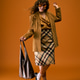 Joyful young woman showcases summer fashion against a vibrant orange backdrop Joyful young woman showcases summer fashion against a vibrant orange backdrop - PhotoDune Item for Sale