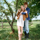 Young couple enjoying a summer day in nature with a boho chic vibe Young couple enjoying a summer day in nature with a boho chic vibe - PhotoDune Item for Sale