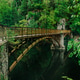 Spring lake, green forest, 19th century metal bridge over stream, Sudetes Poland. Spring lake, green forest, 19th century metal bridge over stream, Sudetes Poland. - PhotoDune Item for Sale