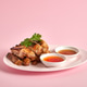 Thai Gai Yang grilled chicken, sliced and served with spicy dipping sauce and fresh cilantro. Thai Gai Yang grilled chicken, sliced and served with spicy dipping sauce and fresh cilantro. - PhotoDune Item for Sale