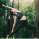 Asian woman practicing yoga in Warrior Pose (Virabhadrasana) on the mat in outdoor park. Asian woman practicing yoga in Warrior Pose (Virabhadrasana) on the mat in outdoor park. - PhotoDune Item for Sale